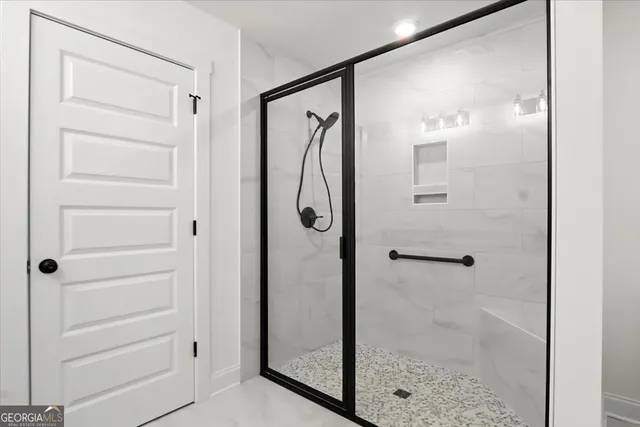 a bathroom with a glass shower door
