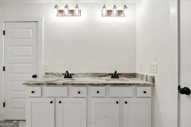 a bathroom with a granite countertop sink a shower and a mirror