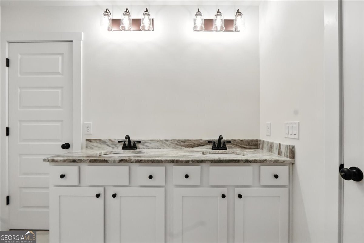 166 Rachel Lane Hartwell, GA 30643 - Photo 39 of 51 a bathroom with a granite countertop sink and a mirror