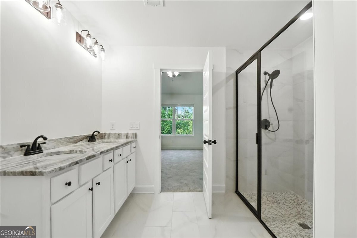 166 Rachel Lane Hartwell, GA 30643 - Photo 41 of 51 a bathroom with a granite countertop sink a shower and a mirror