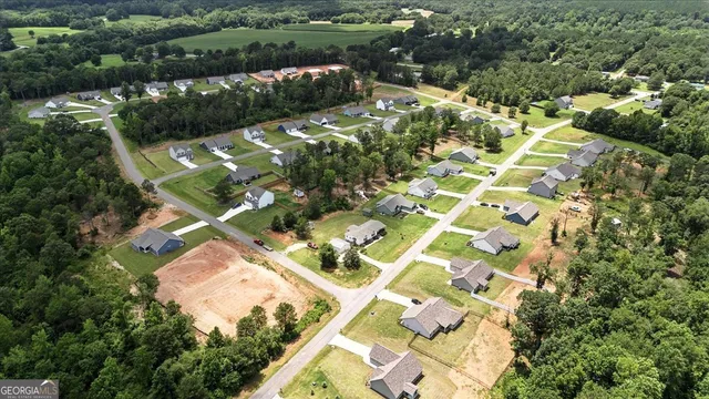 an aerial view of residential house with parking
