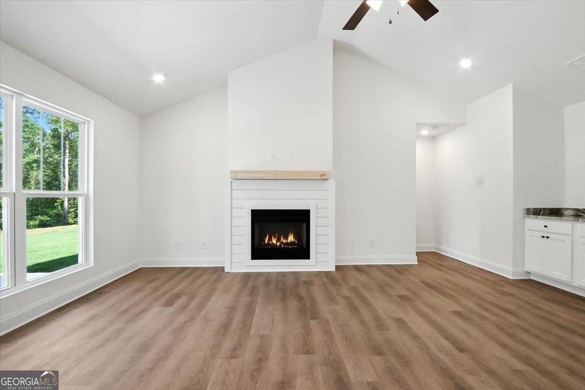 166 Rachel Lane Hartwell, GA 30643 - Photo 4 of 51 a view of an empty room with a window and wooden floor