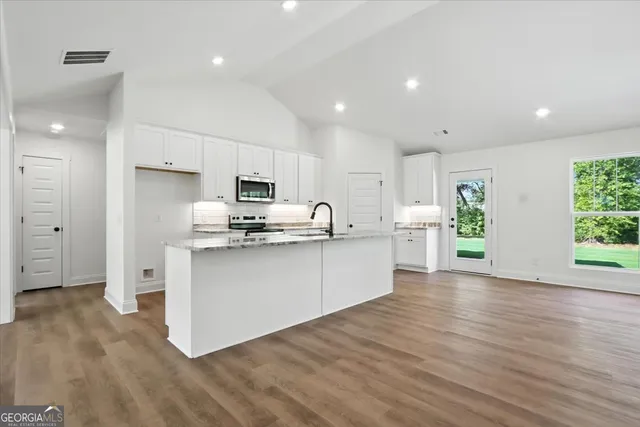 a view of kitchen with wooden floor and window