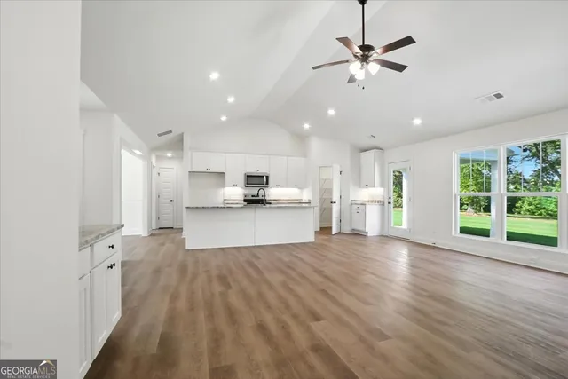 a kitchen with stainless steel appliances a refrigerator sink and cabinets