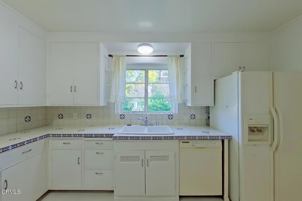 1462 Glengarry Road Pasadena, CA 91105 - Photo 14 of 57 a kitchen with granite countertop a sink cabinets and stainless steel appliances