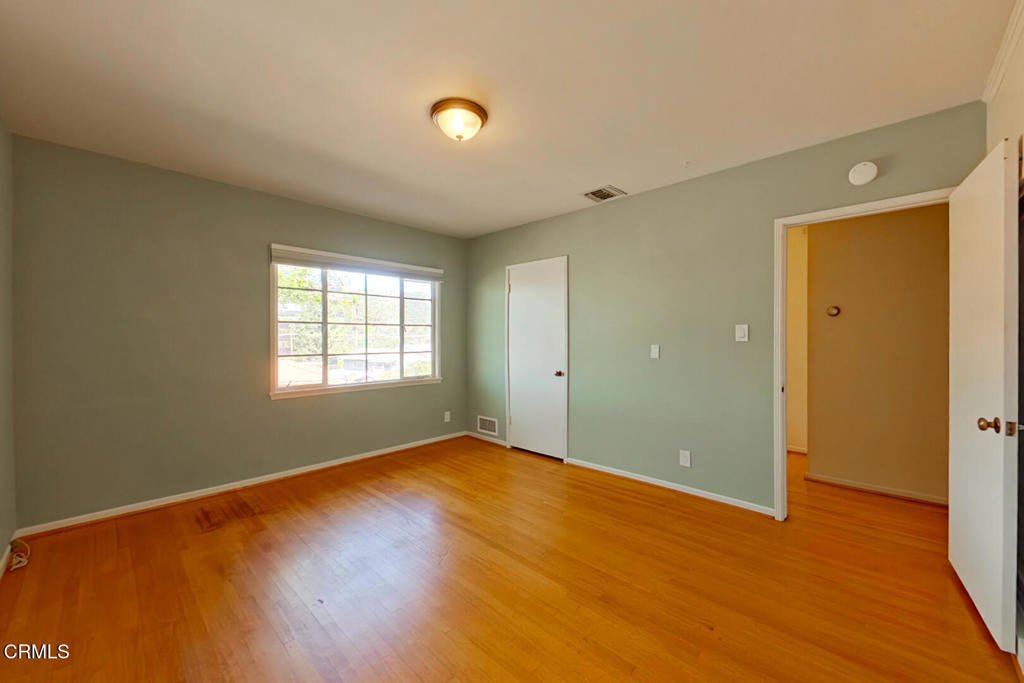 1462 Glengarry Road Pasadena, CA 91105 - Photo 24 of 57 a view of an empty room with wooden floor and a window