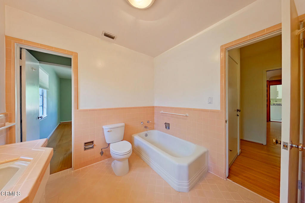 1462 Glengarry Road Pasadena, CA 91105 - Photo 26 of 57 a bathroom with a toilet a sink and a mirror