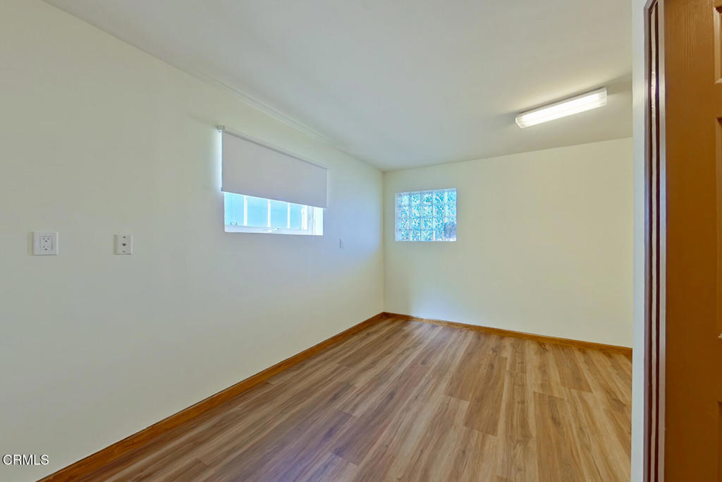 1462 Glengarry Road Pasadena, CA 91105 - Photo 39 of 57 a view of an empty room with wooden floor and a window