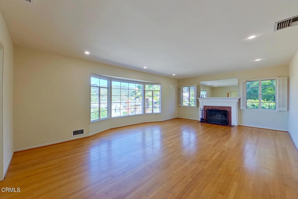 1462 Glengarry Road Pasadena, CA 91105 - Photo 4 of 57 a view of empty room with fireplace and wooden floor