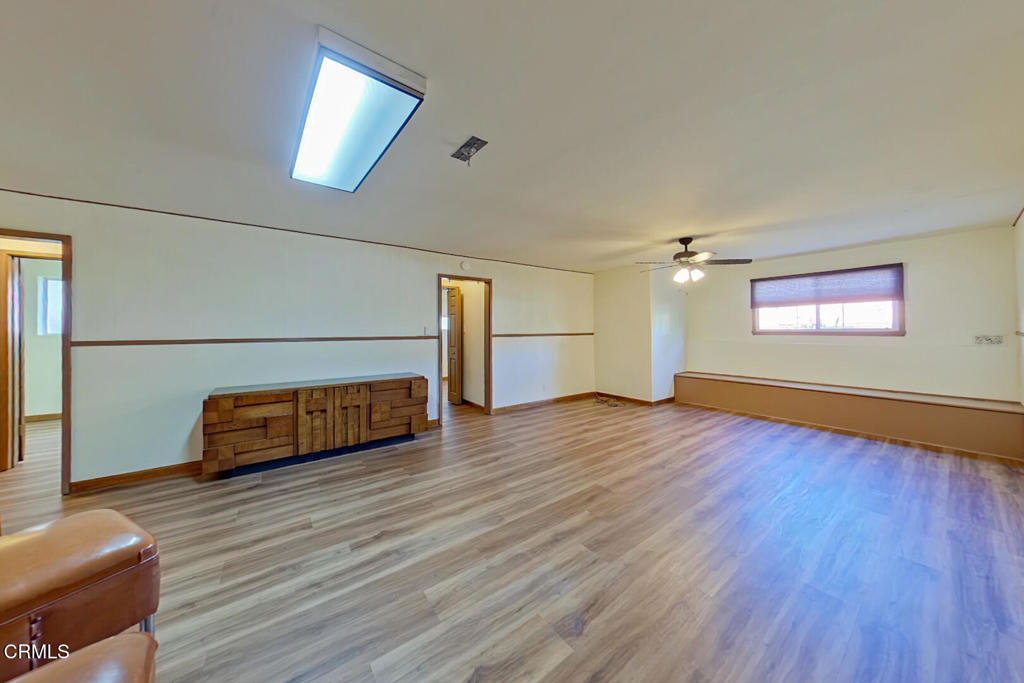 1462 Glengarry Road Pasadena, CA 91105 - Photo 41 of 57 an empty room with wooden floor cabinet and windows