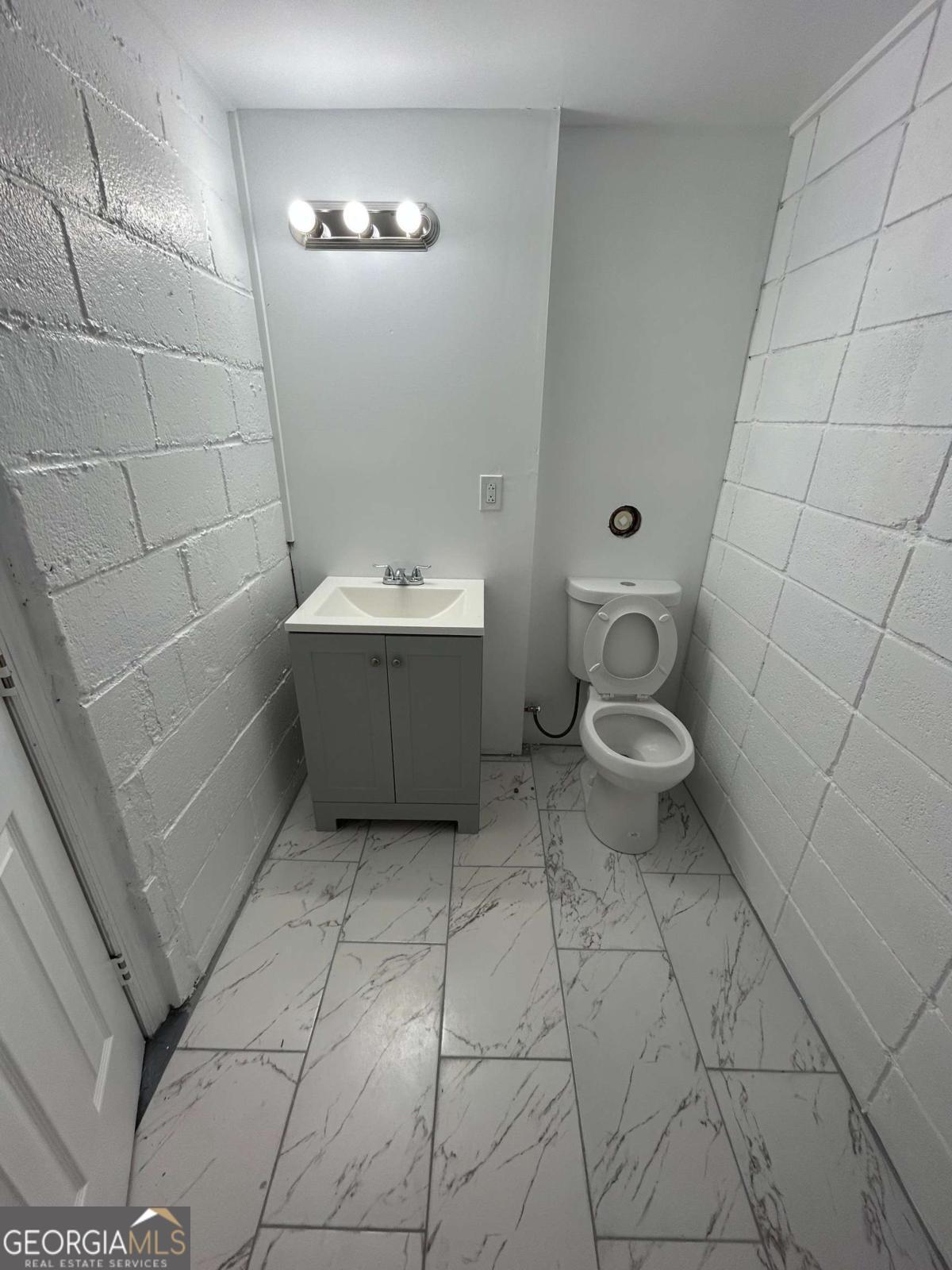 3441 Antioch Heights Macon, GA 31206 - Photo 5 of 11 a bathroom with a sink a toilet and a mirror