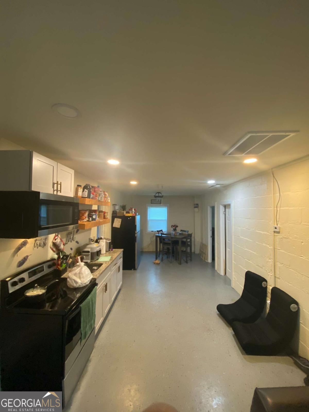 3441 Antioch Heights Macon, GA 31206 - Photo 9 of 11 a kitchen with stainless steel appliances kitchen island granite countertop a stove and a refrigerator