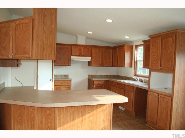 7571 Sam Hall Road Oxford, NC 27565 - Photo 5 of 12 Plenty of cabinet and counter space plus a walk-in panty. Electric range and dishwaser will be added prior to closing.