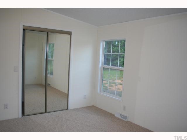 7571 Sam Hall Road Oxford, NC 27565 - Photo 7 of 12 Master bedroom with large walk-in closet w/mirrored door