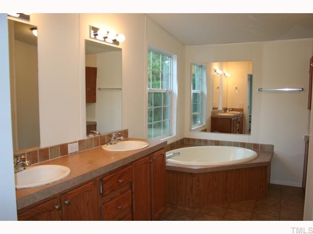 7571 Sam Hall Road Oxford, NC 27565 - Photo 9 of 12 Master bath with double vanity, garden tub and separate shower