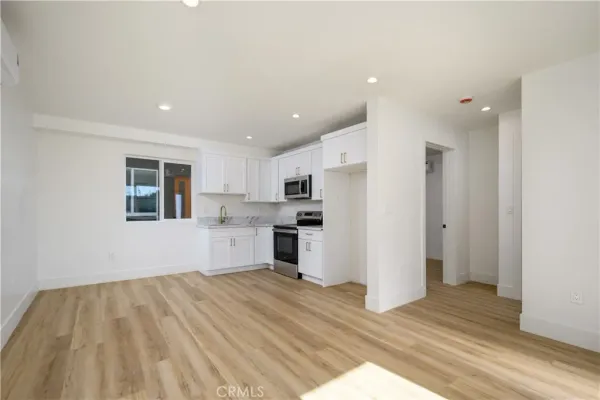 a view of a kitchen with wooden floor