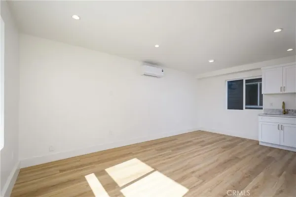 a view of a kitchen with wooden floor and a sink