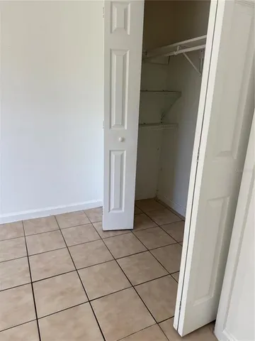 a view of a utility room with washing machine and cabinets