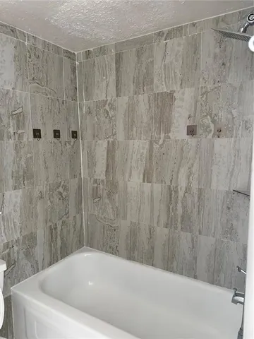 a bathroom with a bathtub and shower