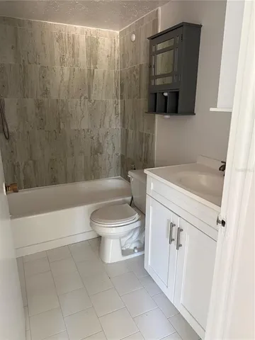 a bathroom with a toilet a sink and bathtub