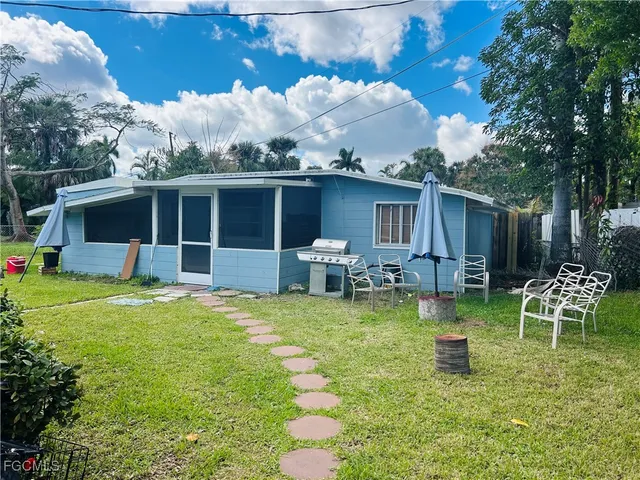 a view of a house with backyard porch and sitting area