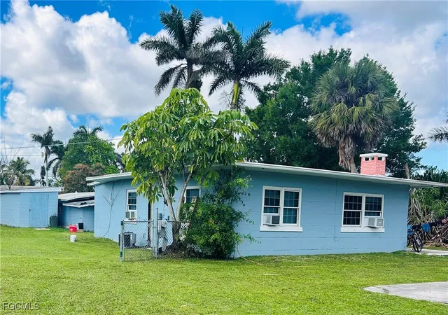 a house that has a tree in front of it