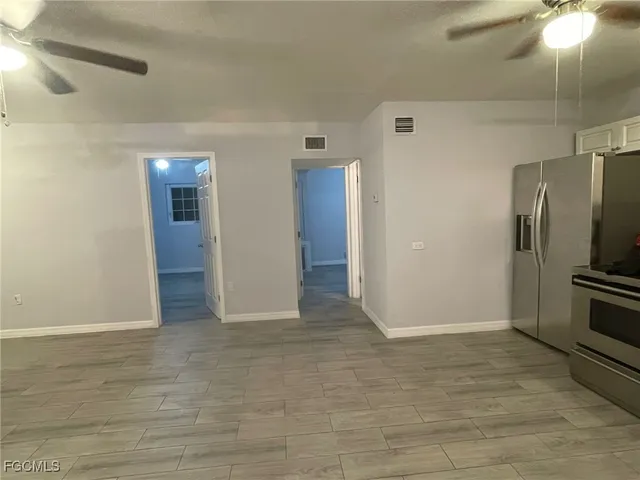 an empty room with wooden floor