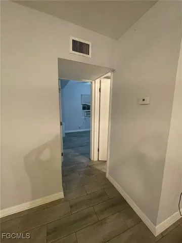 an empty room with an entrance to other room