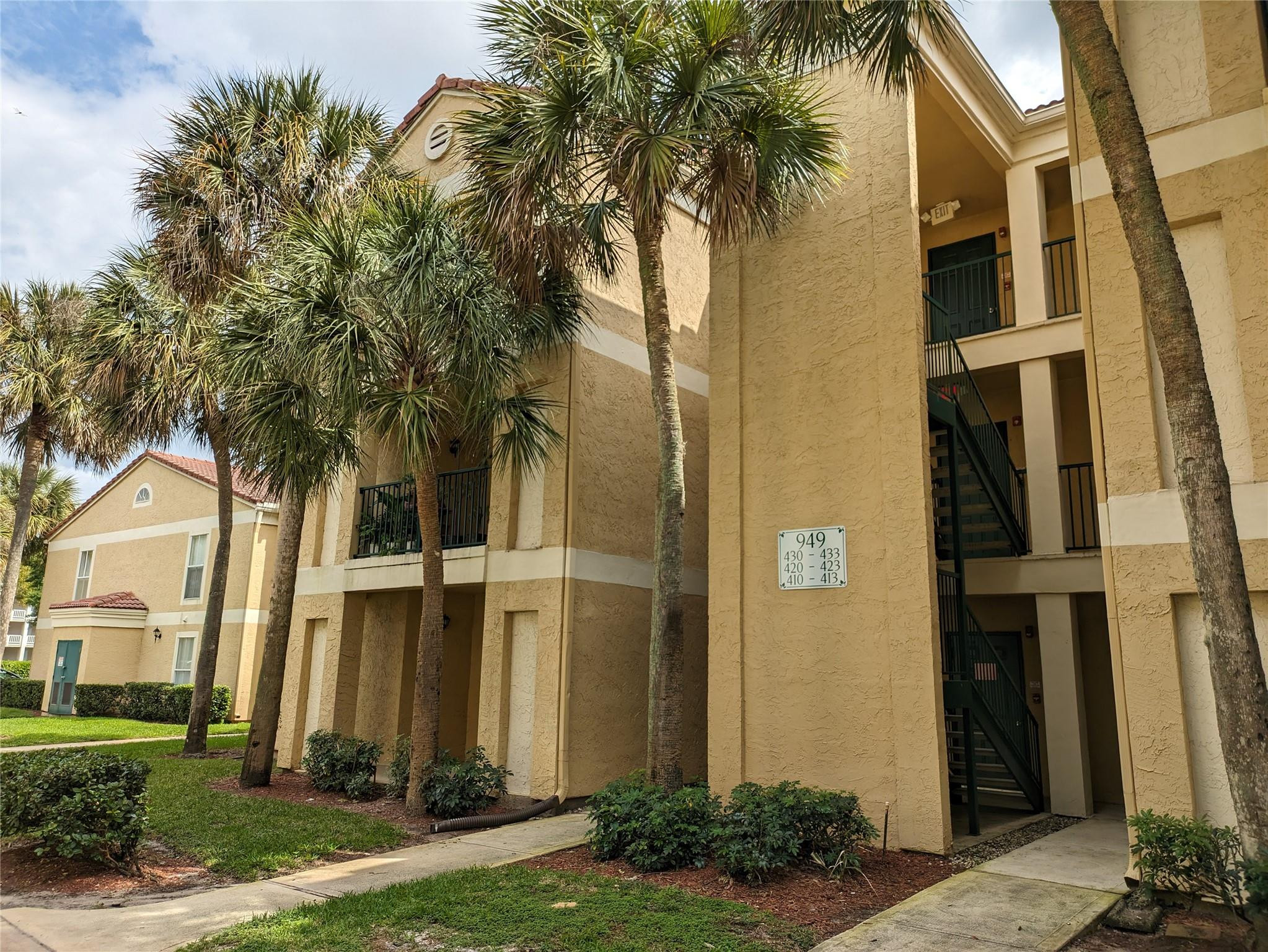 949 Riverside Drive, Unit 411 Coral Springs, FL 33071 - Photo 1 of 15 a front view of a house with a yard