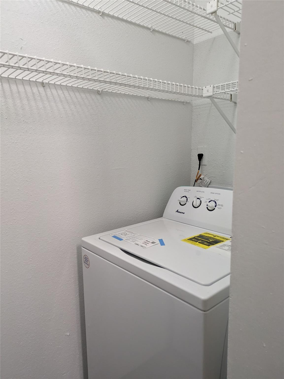 949 Riverside Drive, Unit 411 Coral Springs, FL 33071 - Photo 12 of 15 a utility room with dryer and washer