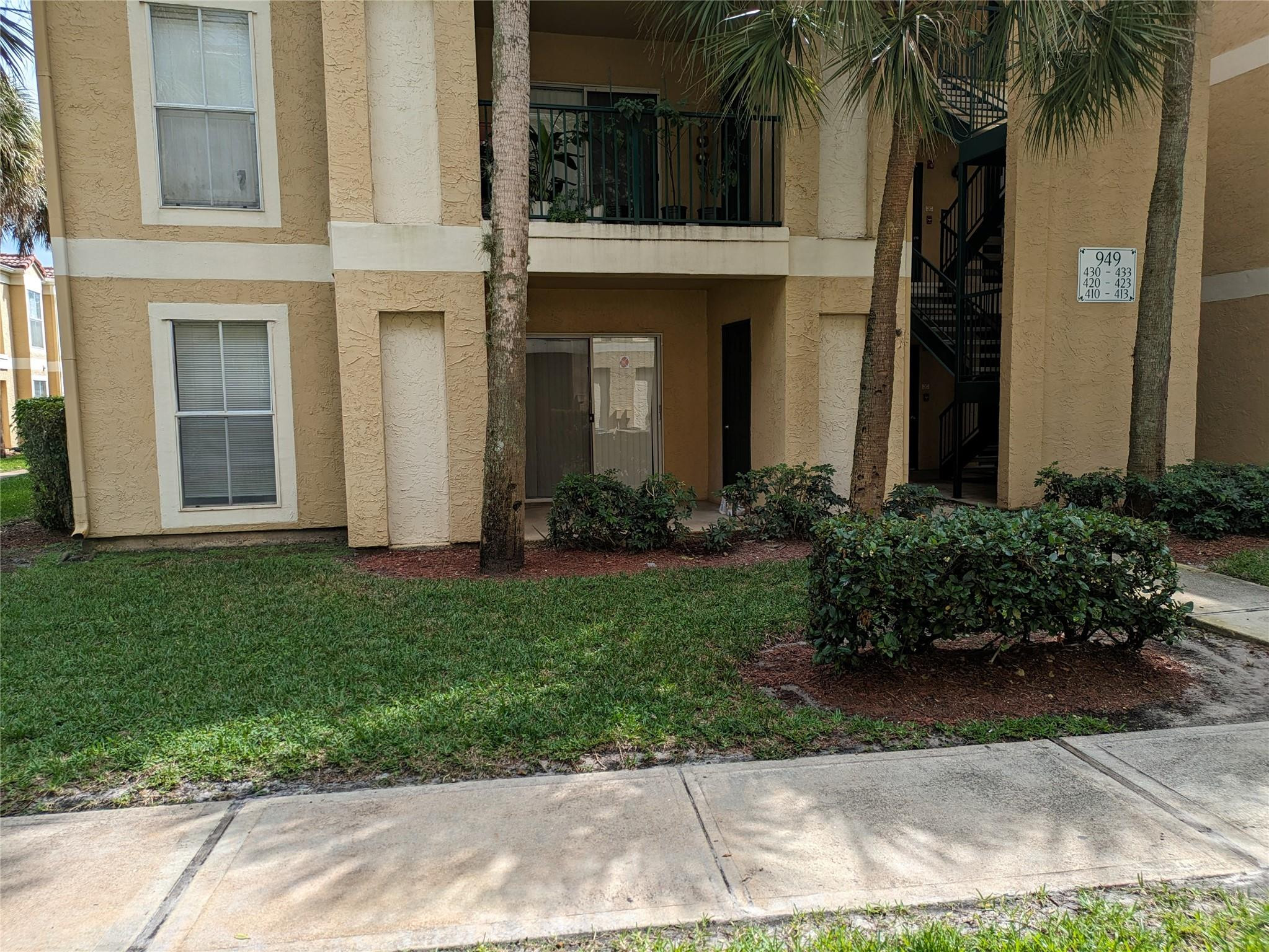 949 Riverside Drive, Unit 411 Coral Springs, FL 33071 - Photo 14 of 15 a front view of a house with a garden