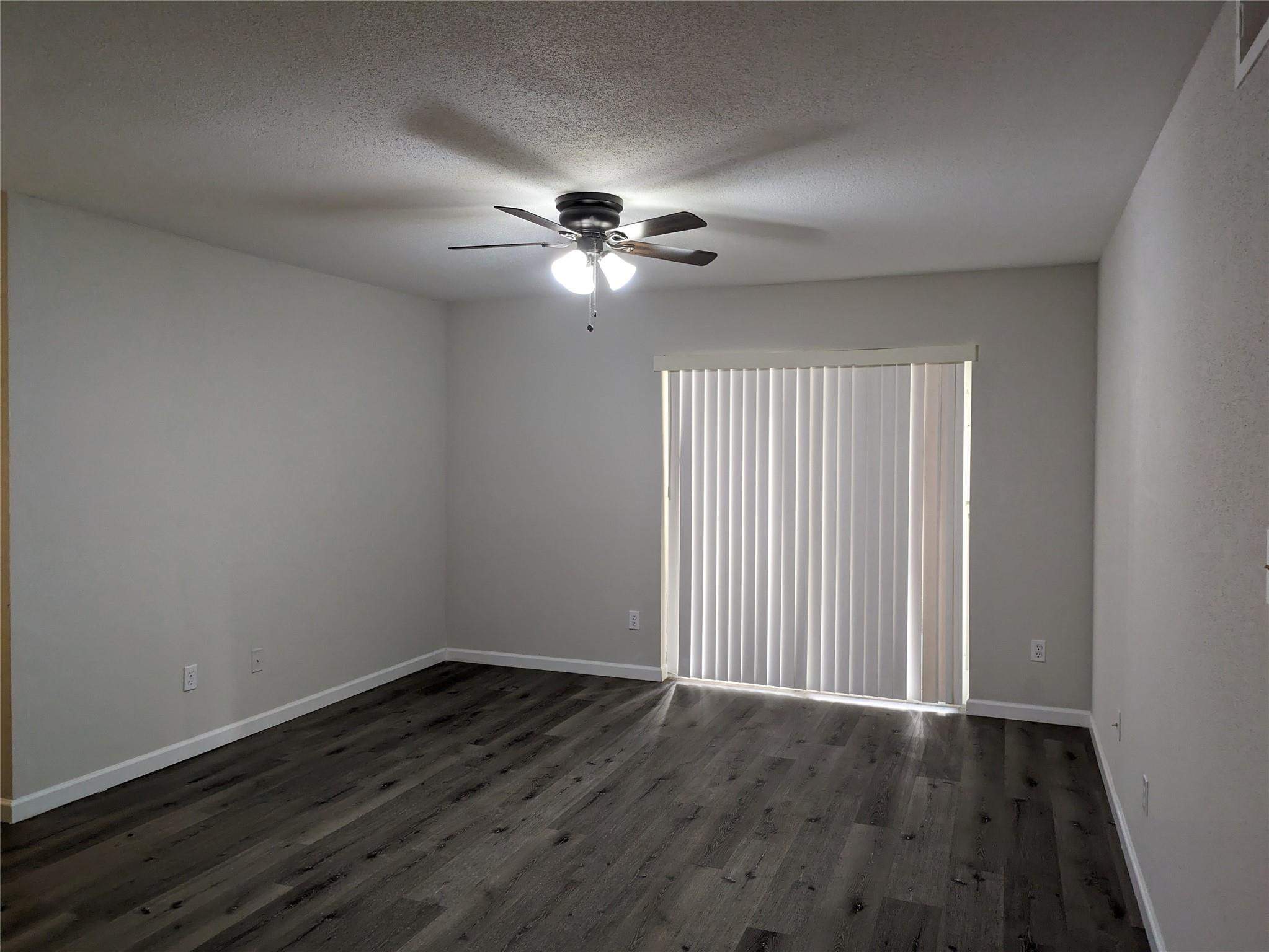 949 Riverside Drive, Unit 411 Coral Springs, FL 33071 - Photo 6 of 15 a view of empty room with wooden floor