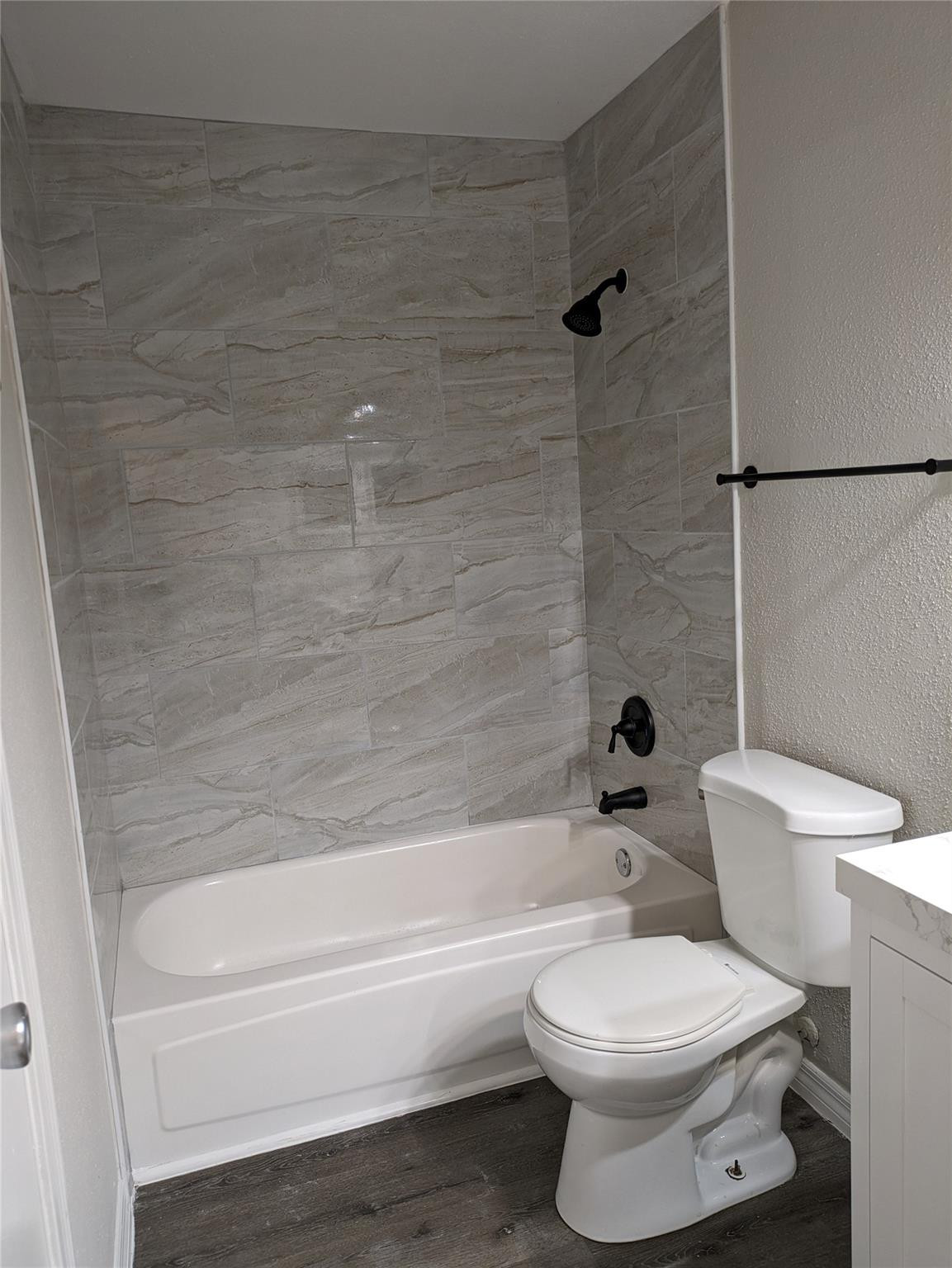 949 Riverside Drive, Unit 411 Coral Springs, FL 33071 - Photo 10 of 15 a bathroom with a toilet and a bath tub