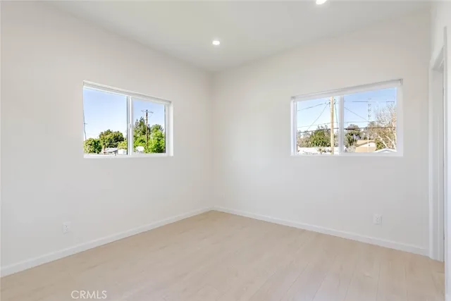 a view of an empty room and a bathroom