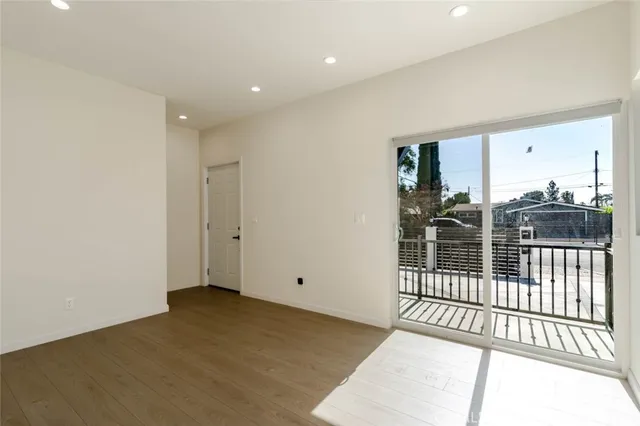 a view of a room with wooden floor