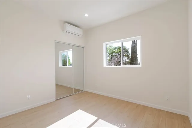 an empty room with windows and closet