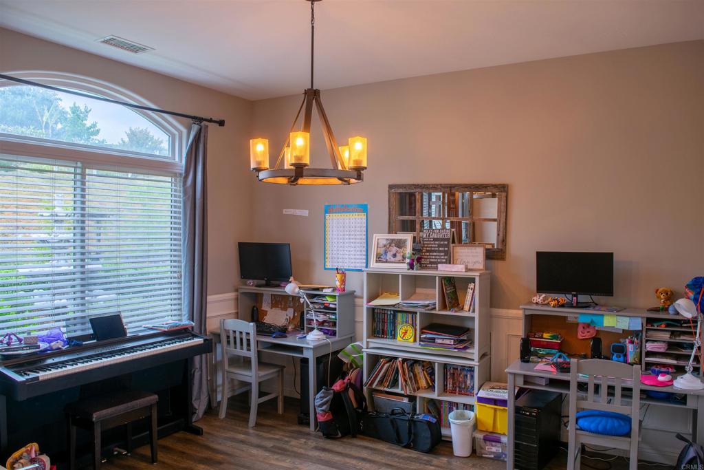 2521 Ralls Street Fallbrook, CA 92028 - Photo 25 of 43 a view of a workspace with bookshelf and a window