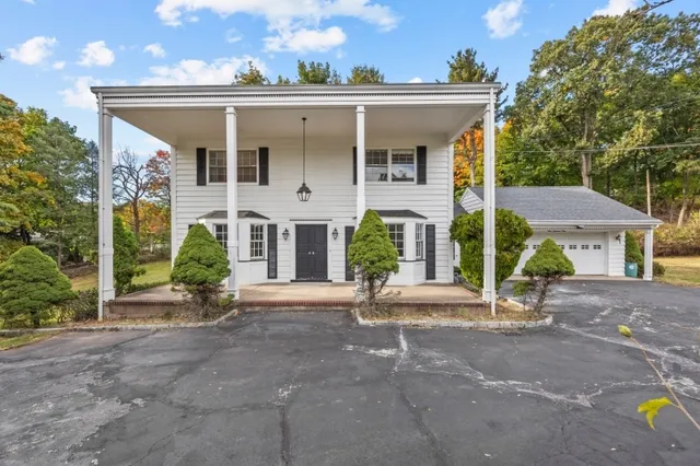 a view of a house with a porch and furniture