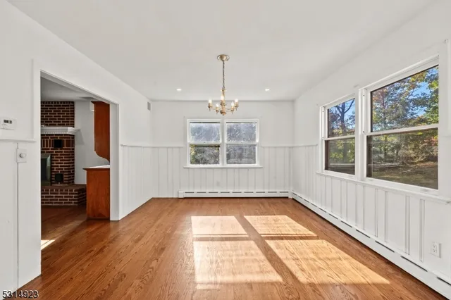 a kitchen with granite countertop white cabinets and stainless steel appliances