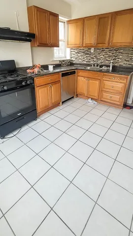 a kitchen with granite countertop a sink and a stove