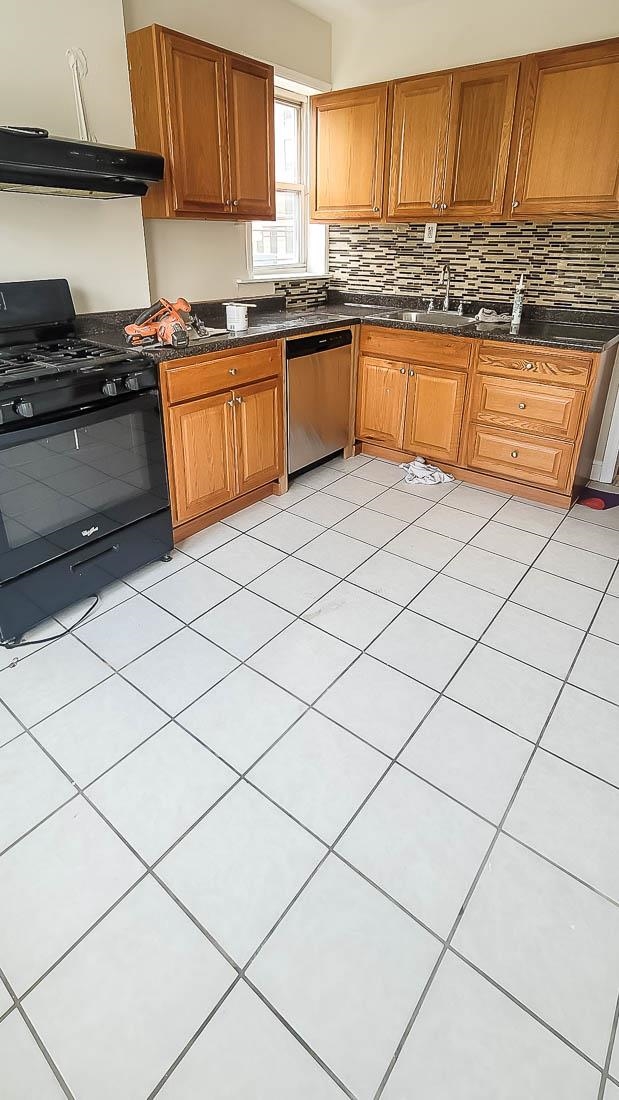 a kitchen with granite countertop a sink and a stove