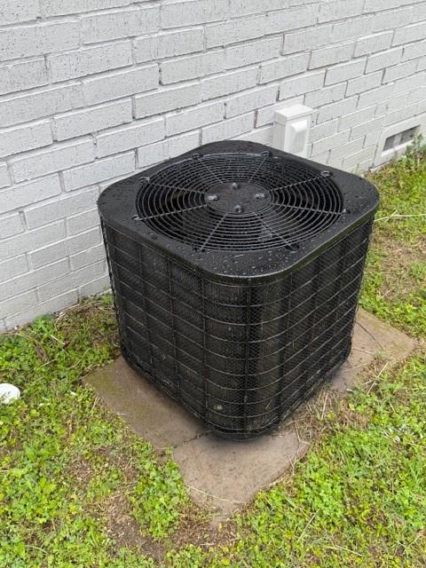 2321 Ridgeview Street Fort Worth, TX 76119 - Photo 10 of 10 Exterior AC unit on a concrete pad with a white painted brick wall