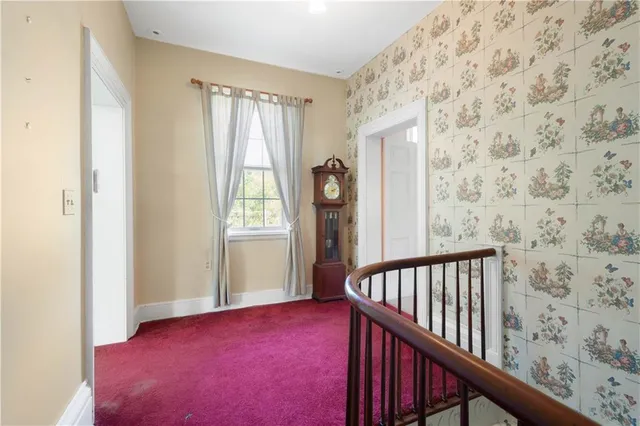 a view of empty room with windows and fireplace