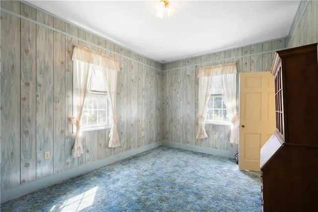 a view of a porch with wooden floor and floor to ceiling window