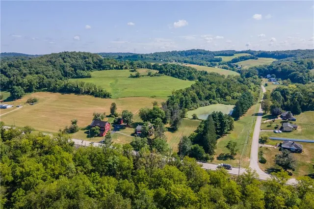an aerial view of a house with a yard and lake view