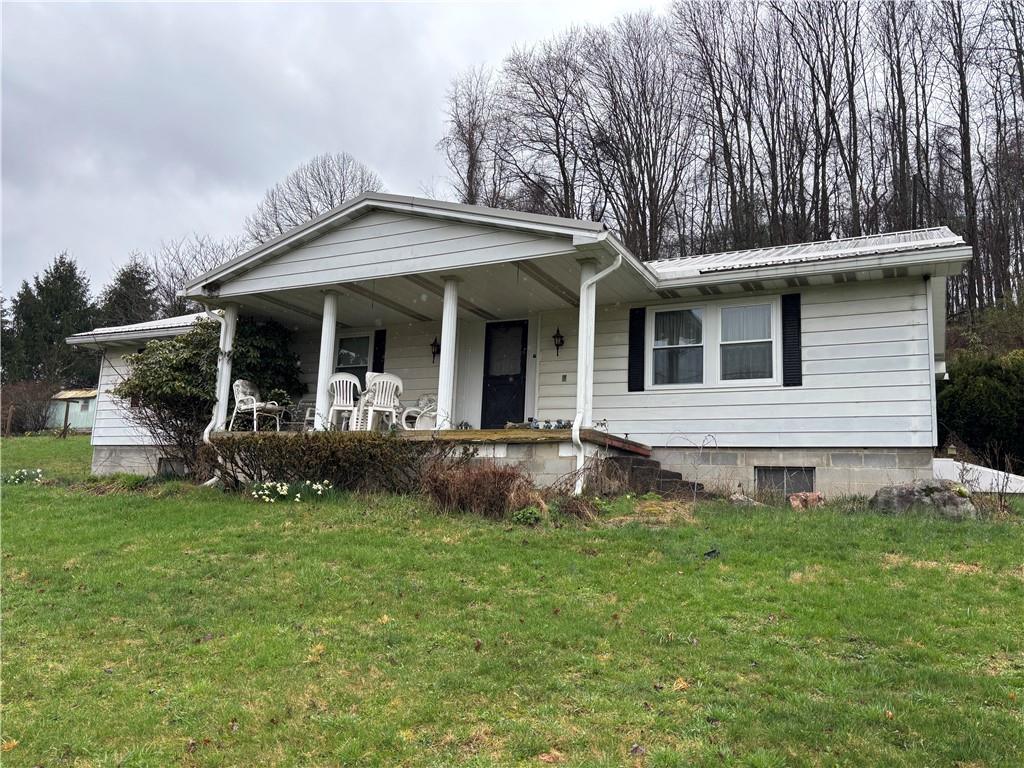 2113 Sebring Road Marion Center, PA 15759 - Photo 1 of 9 a front view of a house with a yard table and chairs