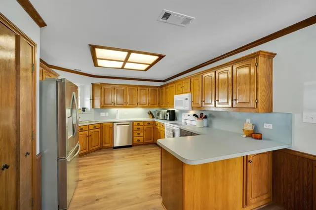 a kitchen with a refrigerator a sink and cabinets