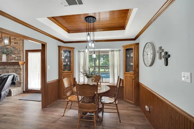 a view of a room with furniture large window and wooden floor