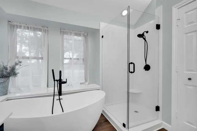 a bathroom with a bath tub and shower