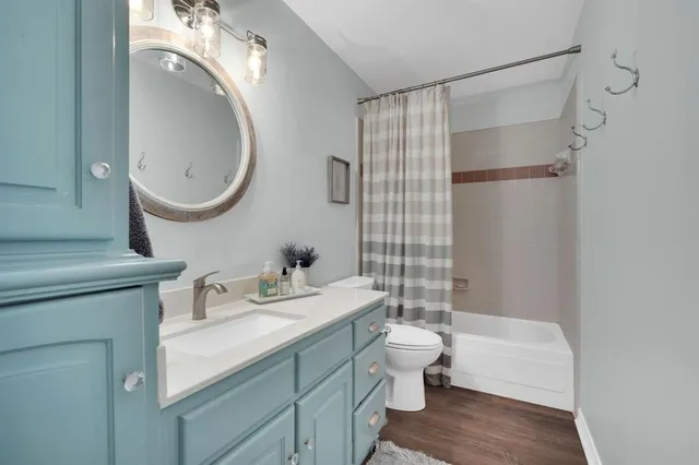 a bathroom with a bathtub shower sink and toilet